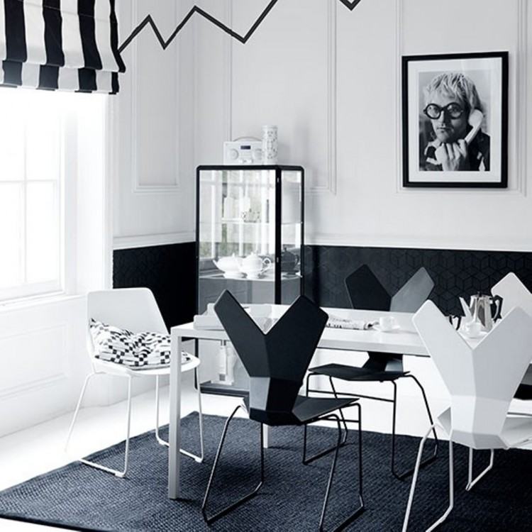 Black and white kitchen with small round table and two chairs in the corner