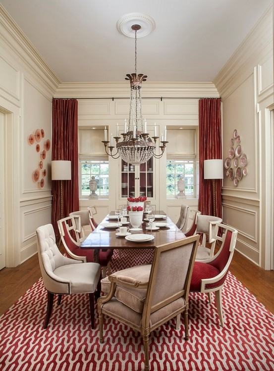 A red centerpiece adds lively energy to a glass dining table