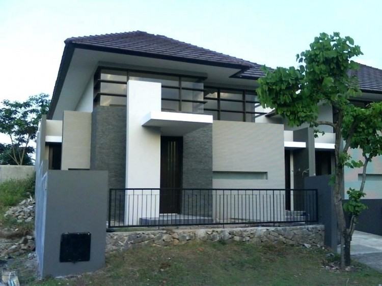 Bricks arranged in different directions create a patchwork design on the  exterior of this family house