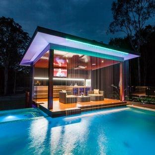 Fireplace and smart seating inside the contemporary pool house [Design:  Wagner Hodgson]