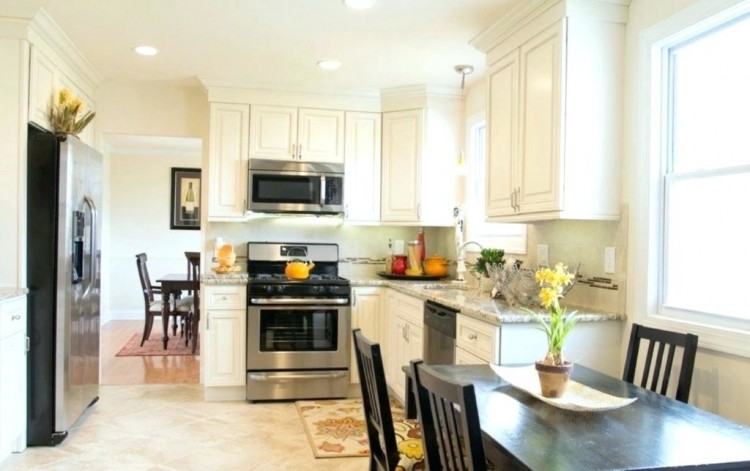 Ivory kitchen cabinets with Mocha Glaze from Homecrest Cabinetry against  light oak hardwood floors