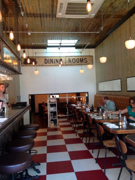 The dining rooms is small but not cramped, a very Parisian café atmosphere,  a casual dining experience where guests engrossed in conversation over a  glass