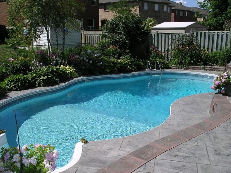 Luxury in ground swimming pool with waterfalls and fire pit design and  installation Mahwah NJ