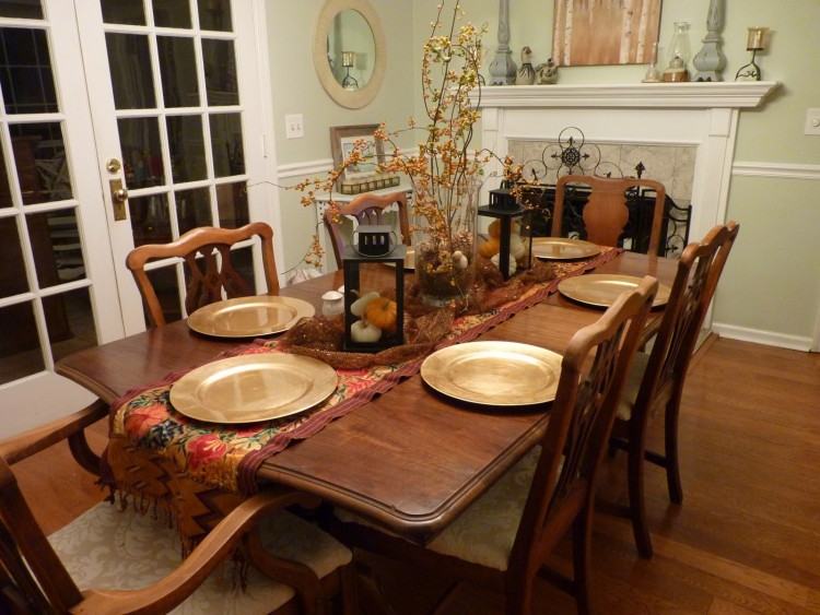 Dining room with dark wood dining table and  grey upholstered dining chairs