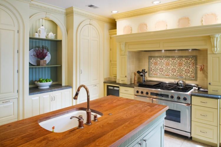 Clean white cabinets, classic Soapstone tops, and a gleaming subway tile  backsplash