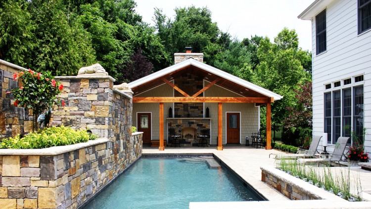 Blue upholstered sun chairs line the length of the pool