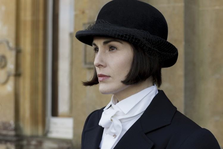 Lady Mary in her wedding gown standing on the staircase at Downton Abbey  castle